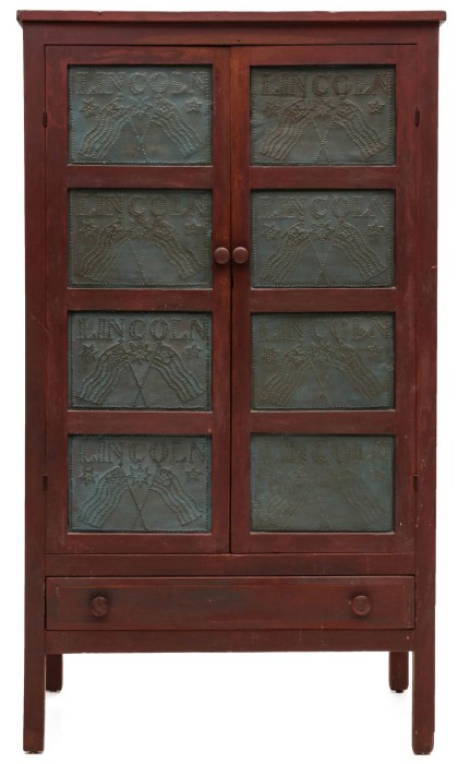 Rare and important painted pie safe with 16 punched tins lettered ‘LINCOLN’ above crossed flags and floating stars. Sold over the phone for $38,420.