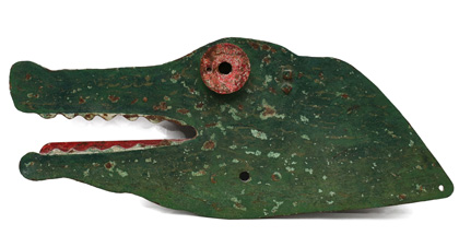 Only known example of a William F. Mangels (Coney Island, NY) cast‑iron folk‑art crocodile target with applied eye that served as the bull’s‑eye, 33 x 13.5in. Pictured in the 2014 reference ‘Step Right Up! Classic American Targets and Arcade Forms,’ as well as in Mangels' catalog.Sold for $23,600