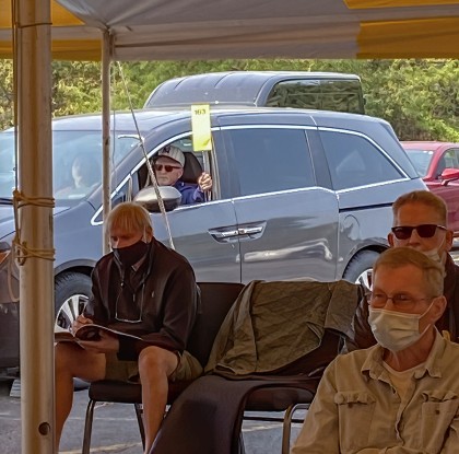 Approximately one dozen spaces were available to reserve ahead of time for drive-up bidding. Each of those particular bidders had the option of monitoring the auction on their FM radio or online through a mobile device, and was given a long‑handled bidding ‘paddle’ fashioned from a fly swatter with a bidding card affixed to it.