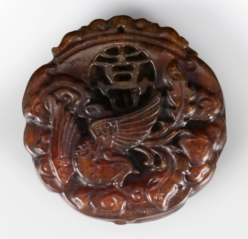 A CHINESE HARD STONE CARVED DISC PENDANT