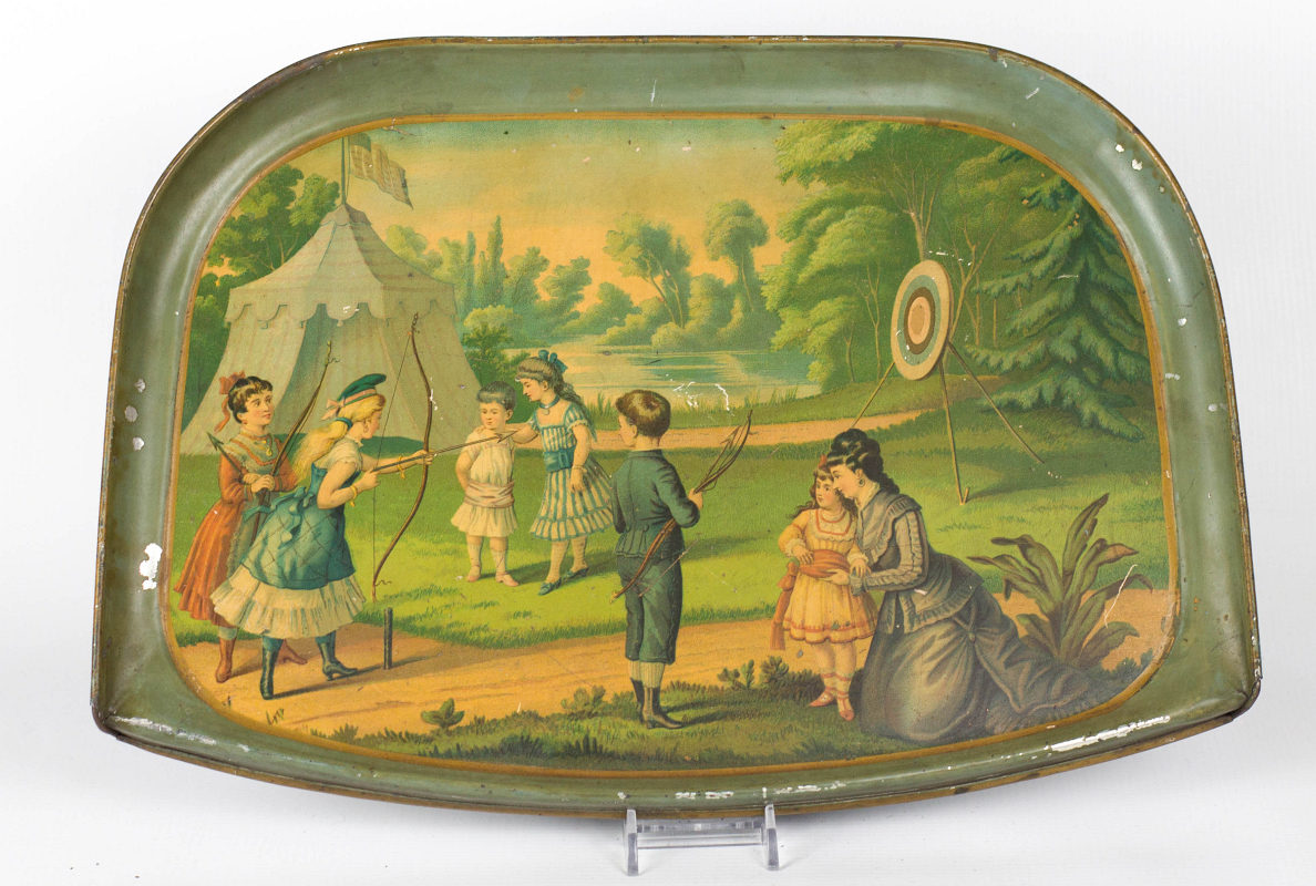 A TIN LITHO HIGH CHAIR TRAY WITH AN ARCHERY SCENE