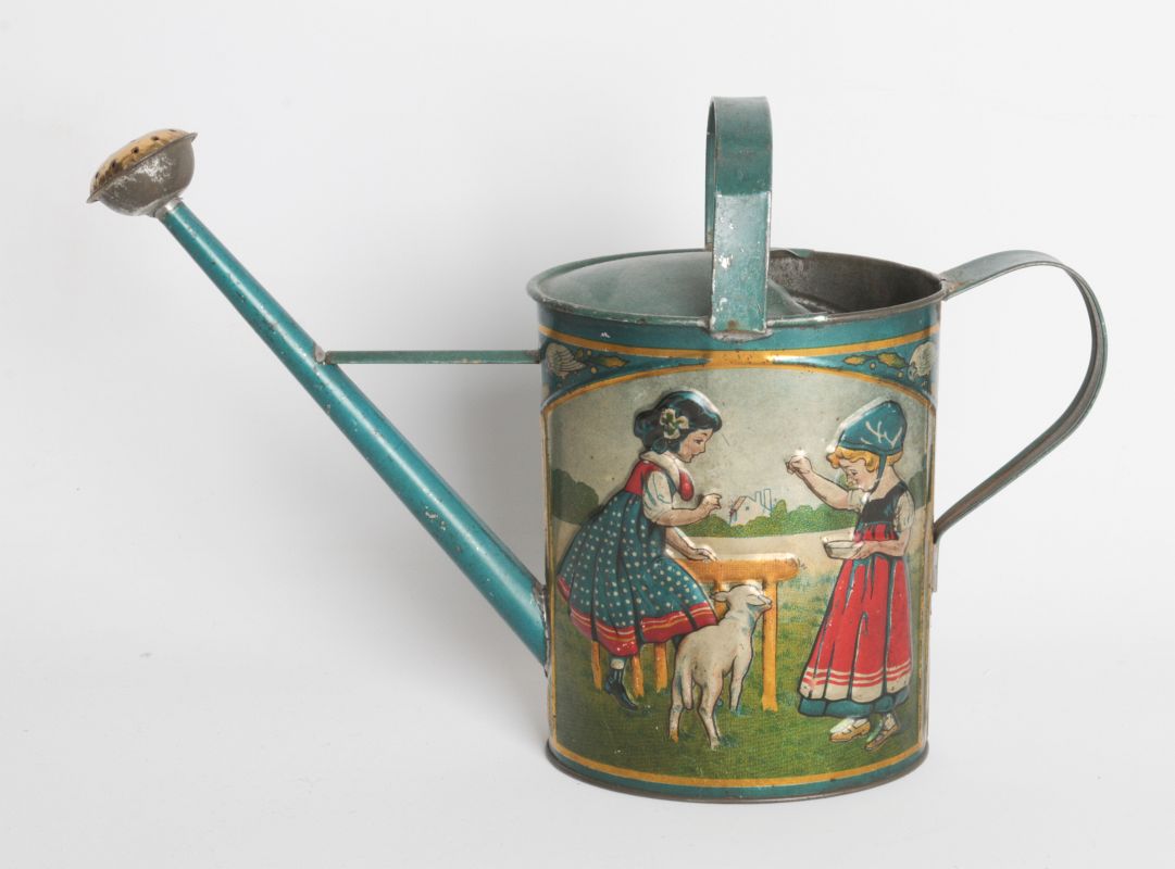 AN EMBOSSED TIN LITHO VICTORIAN TOY WATERING CAN