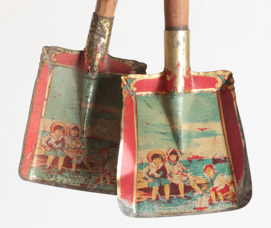 A PAIR OF VICTORIAN TIN LITHO CHILD'S SAND SHOVELS