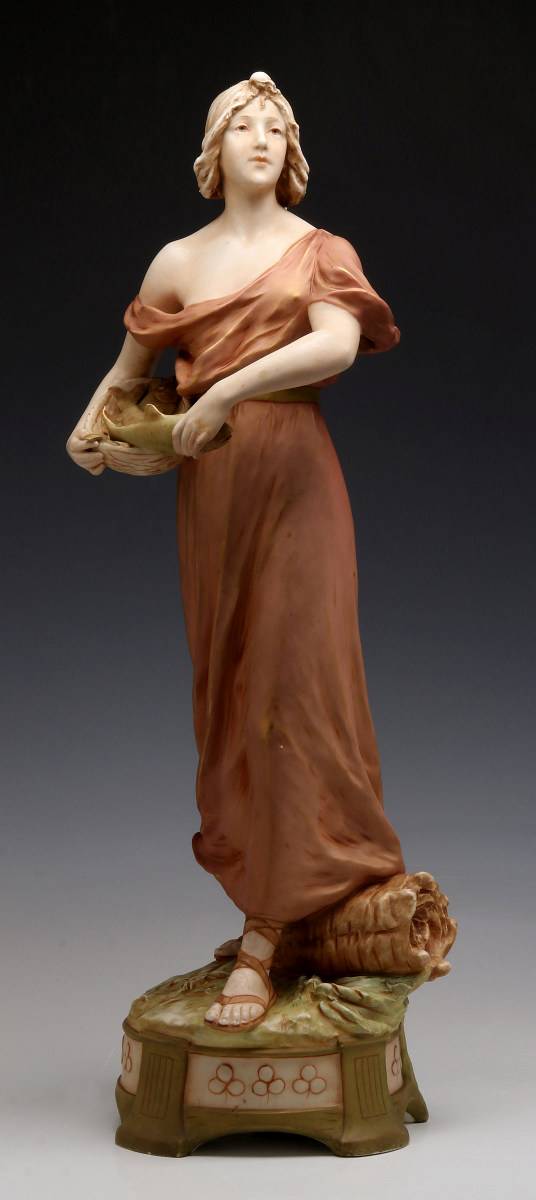 A ROYAL DUX FIGURE OF A WOMAN WITH FISH