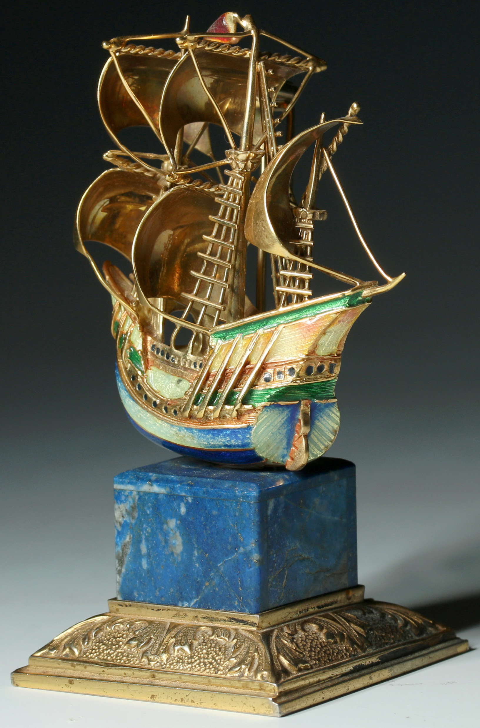 AN 18K GOLD ENAMEL MASTED SHIP PIN ON LAPIS STAND