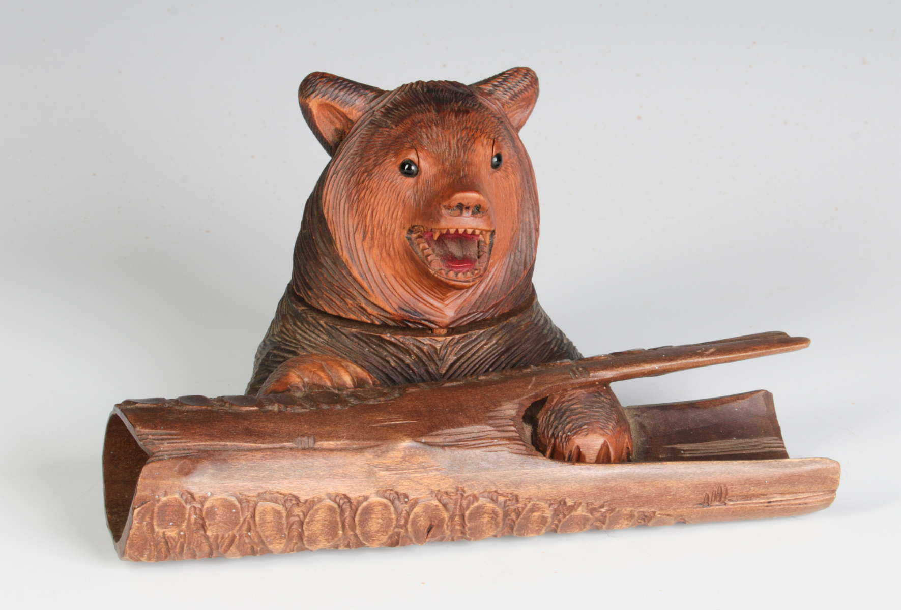 A BLACK FOREST CARVED BEAR AND LOG FIGURAL INKWELL