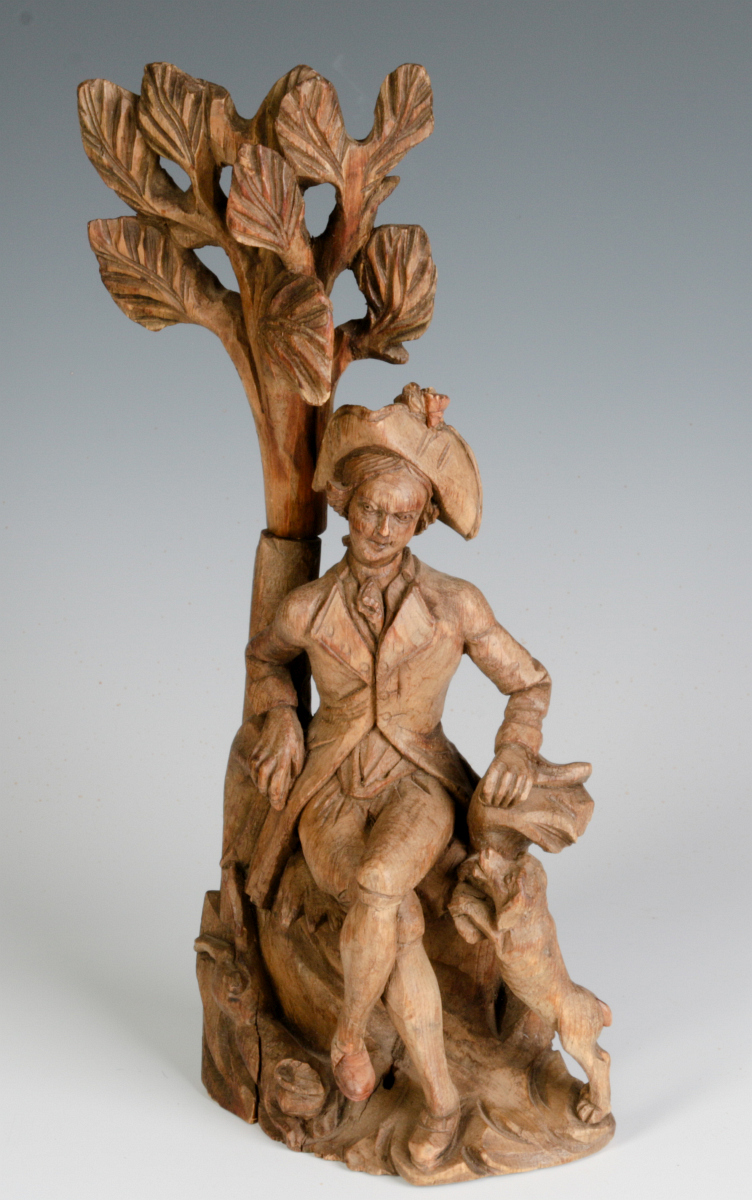 AN 18TH C. WOOD CARVING OF A GENTLEMAN AND HIS DOG