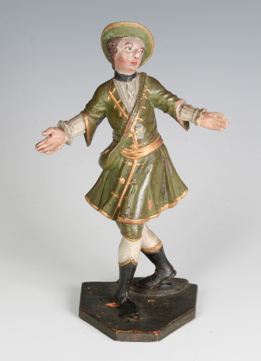A 19TH C. CONTINENTAL CARVED AND PAINTED FIGURE