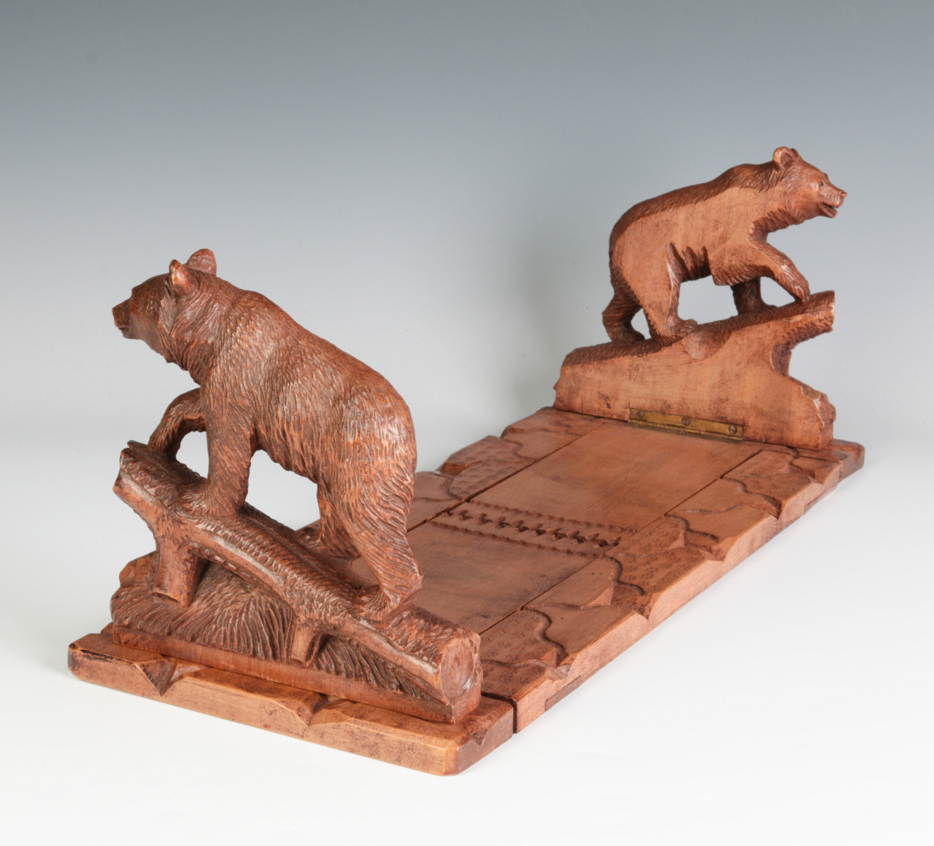 AN EARLY 20TH C BLACK FOREST BOOK STAND WITH BEARS
