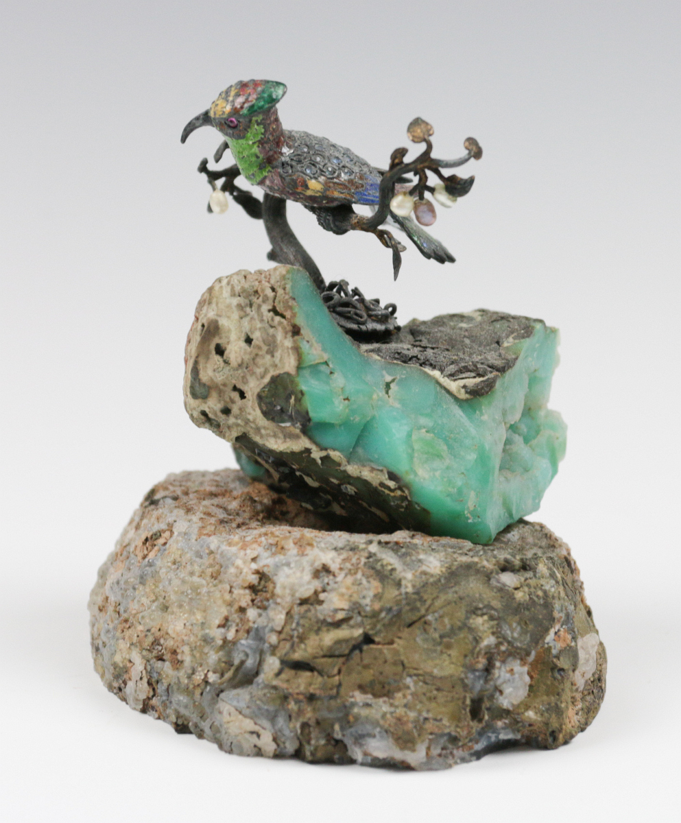 A SMALL EMBELLISHED BRONZE FIGURE ON GEODE