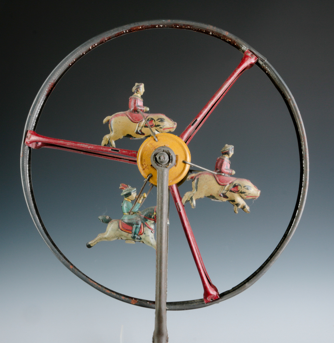 A CHILD'S TIN LITHO ROLL-A-LONG WHEEL TOY C. 1900