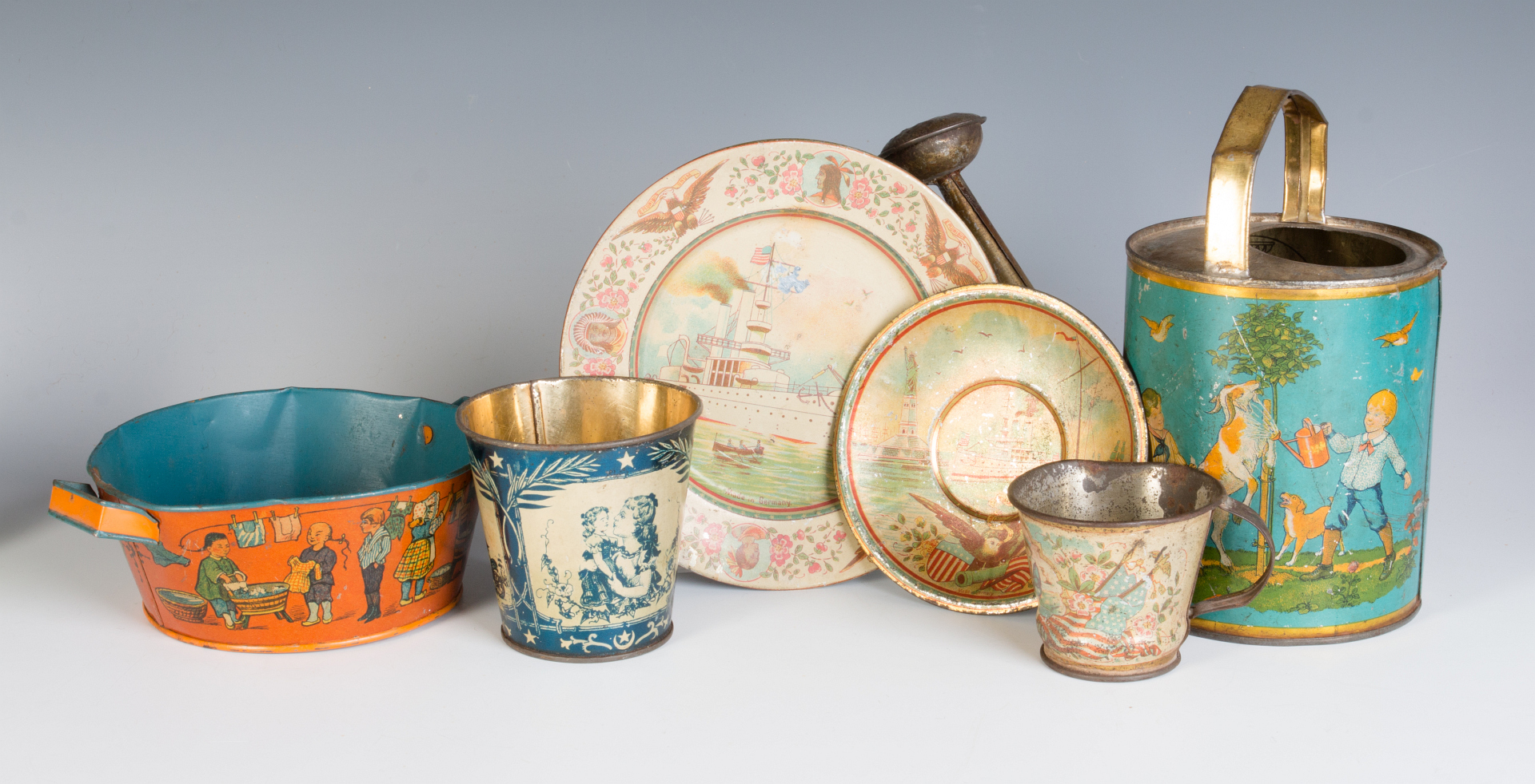 A GROUP OF TIN LITHO CHILDREN'S DISHES AND TOYS
