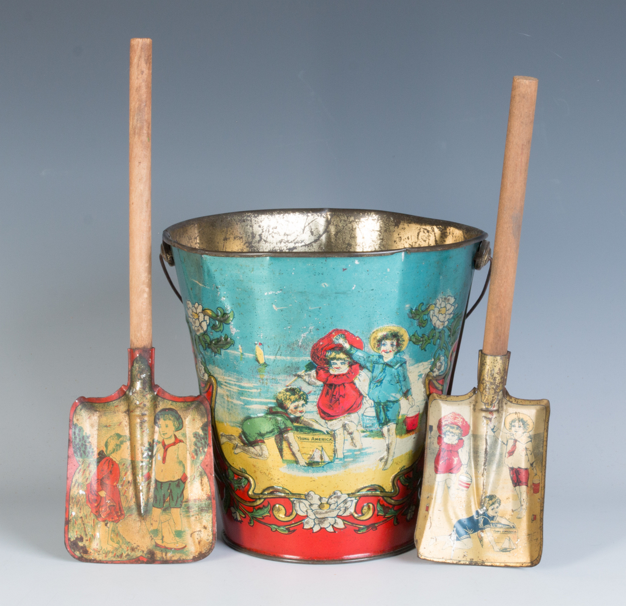 A 19TH CENTURY VICTORIAN SAND PAIL AND TWO SHOVELS