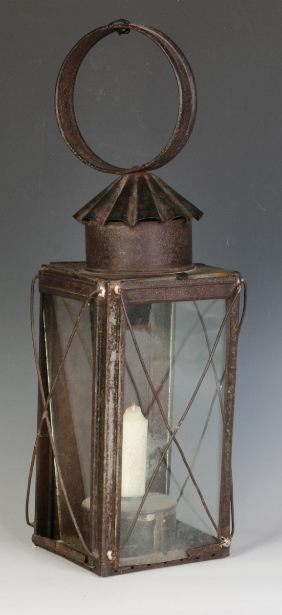 A 19TH CENTURY TIN AND GLASS CANDLE LANTERN