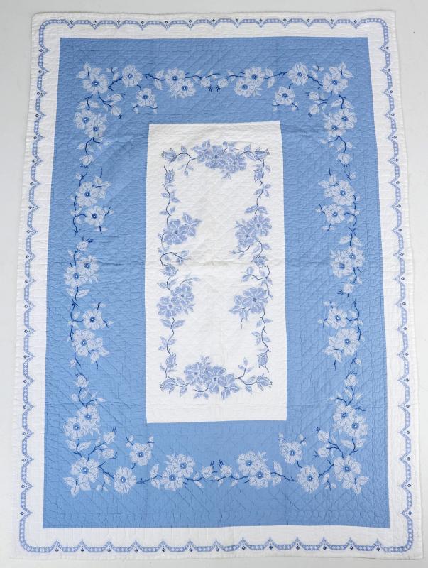 A VINTAGE BLUE AND WHITE EMBROIDERED QUILT
