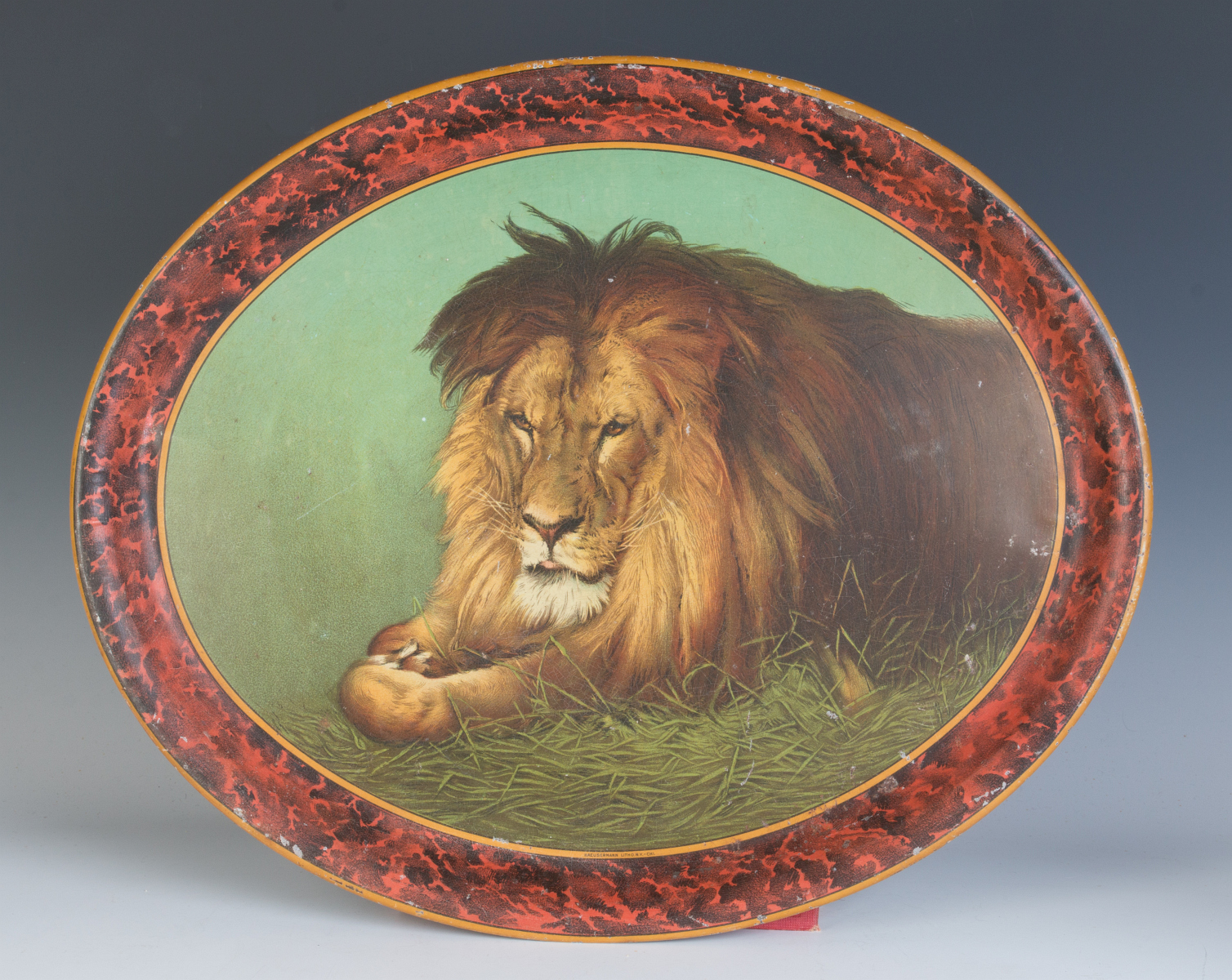A CIRCA 1910 LITHOGRAPHED TIN TRAY WITH LION