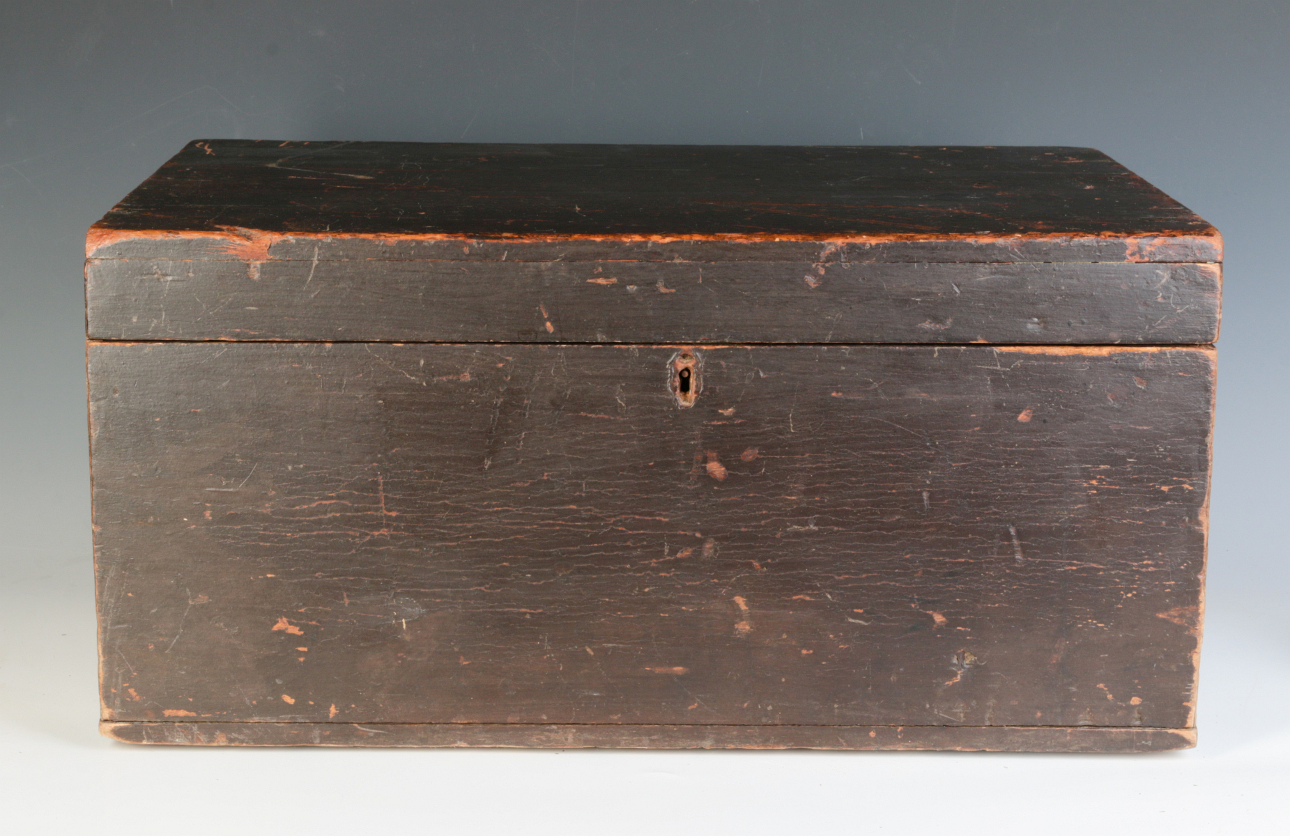 A 19TH CENTURY STORAGE BOX IN OLD BROWN PAINT