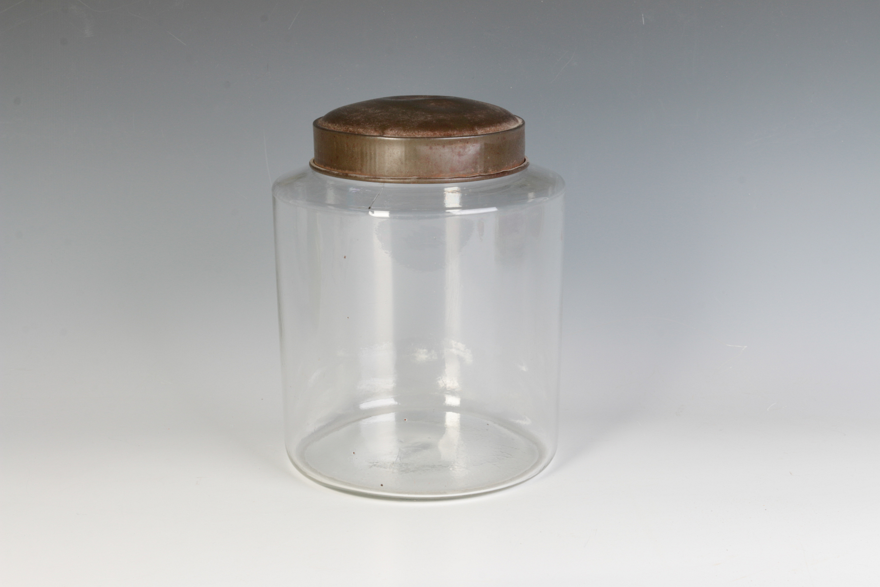 AN EARLY BLOWN GLASS STORAGE JAR WITH TOLE LID