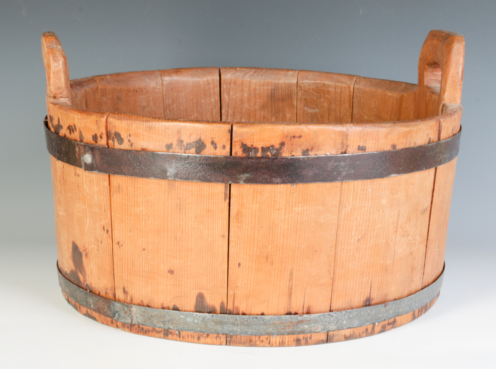 A 19TH CENTURY BUCKET WITH HIGH STAVE HANDLES