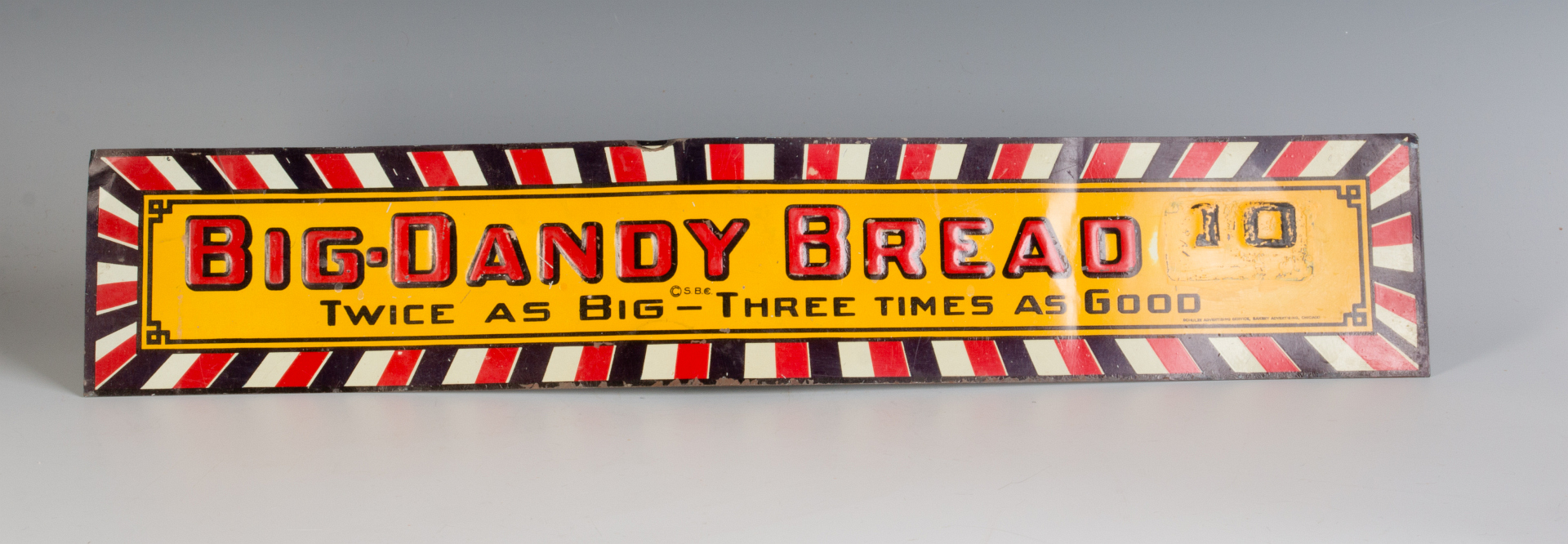 A VINTAGE EMBOSSED TIN SIGN FOR BIG DADDY BREAD