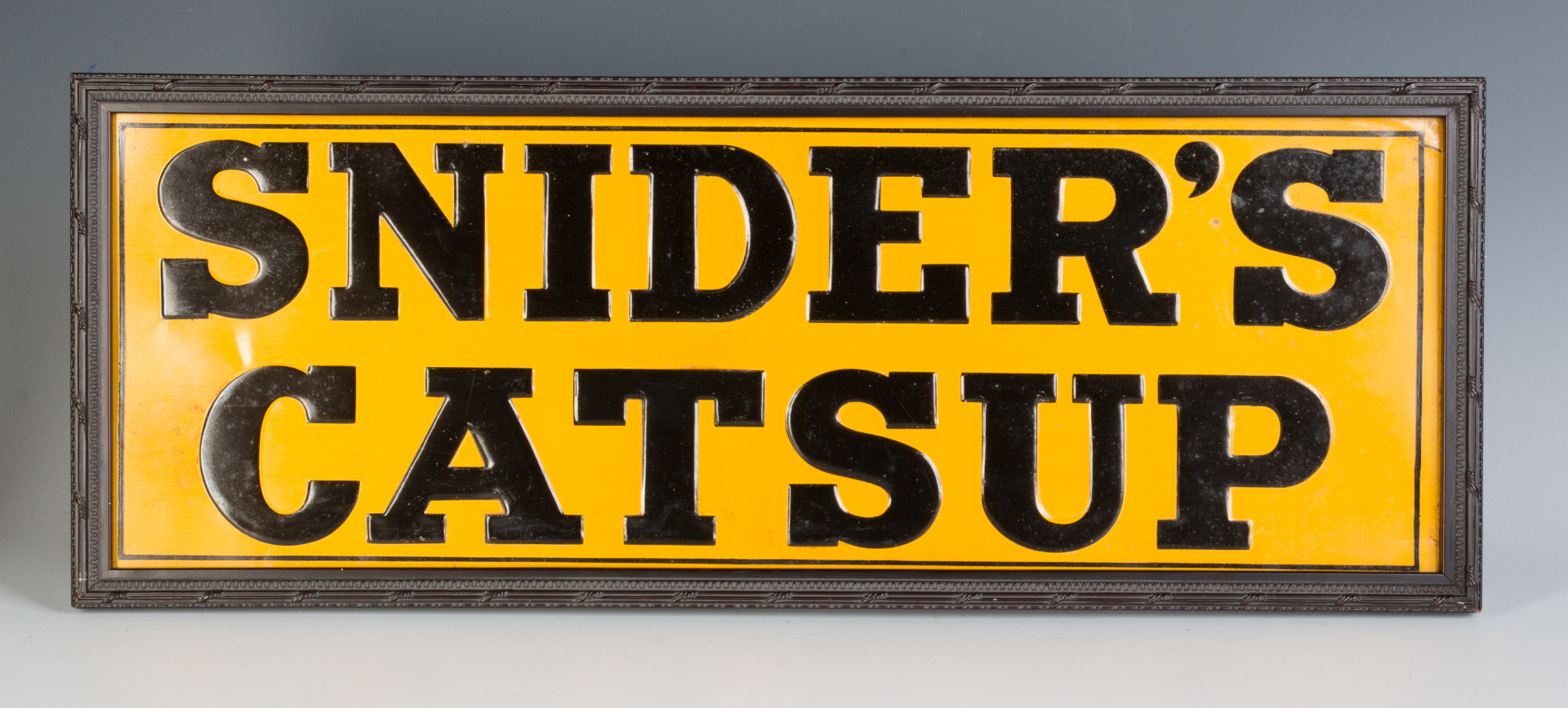 A NICE EMBOSSED TIN SIGN FOR SNIDER'S CATSUP