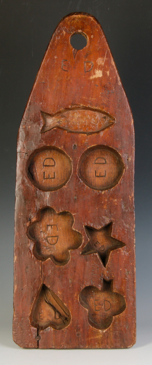 A 19TH CENTURY CARVED PINE COOKIE BOARD