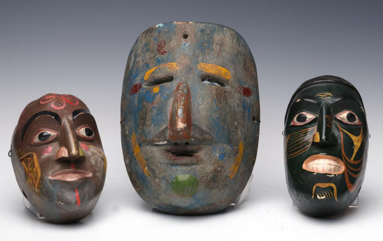 A COLLECTION OF SOUTH AMERICAN CARVED WOOD MASKS