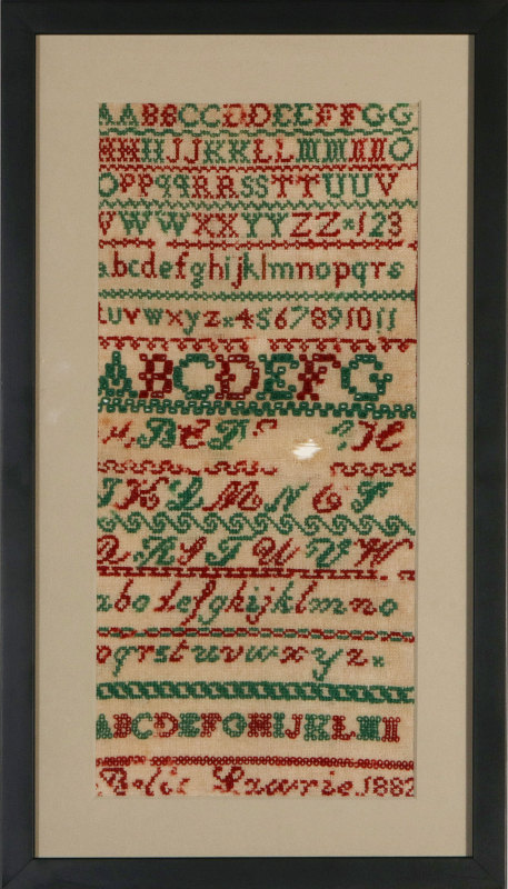 A TWO-COLOR CROSS STITCH SAMPLER DATED 1882
