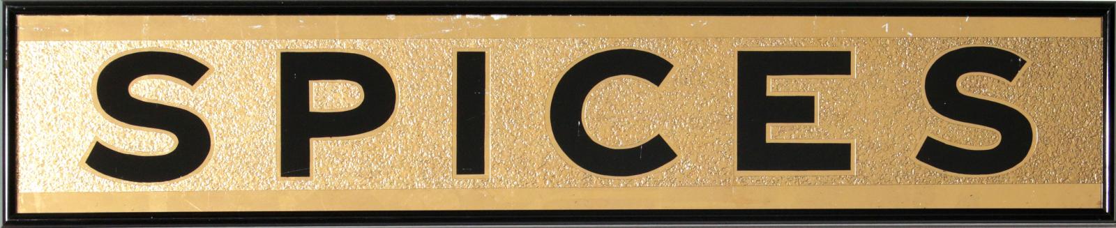 A BLACK AND GOLD 'SPICES' REVERSE PAINTED SIGN