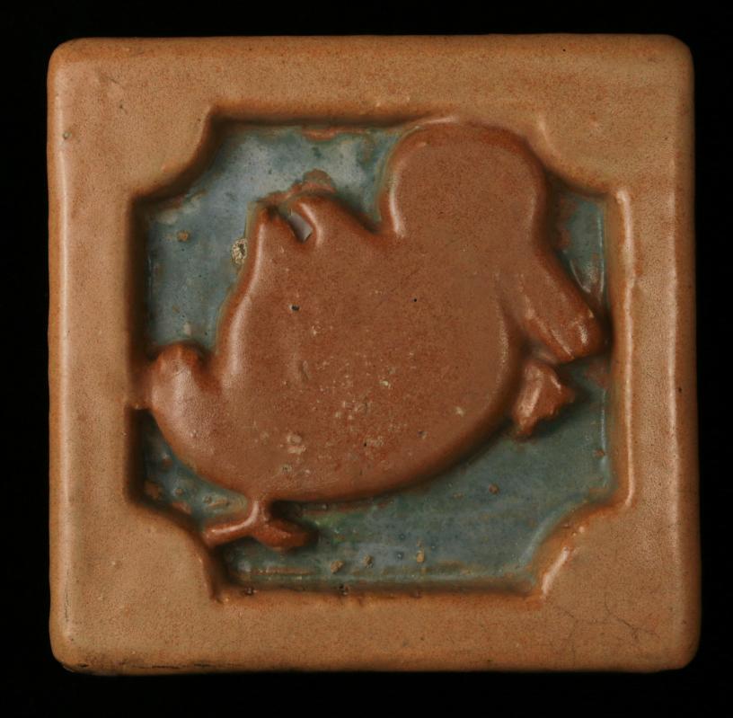 A DEEPLY CARVED TERRA COTTA ARCHITECTURAL TILE