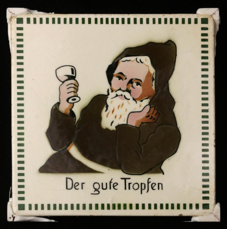 A CIRCA 1900 GERMAN TILE WITH IMBIBING MONK