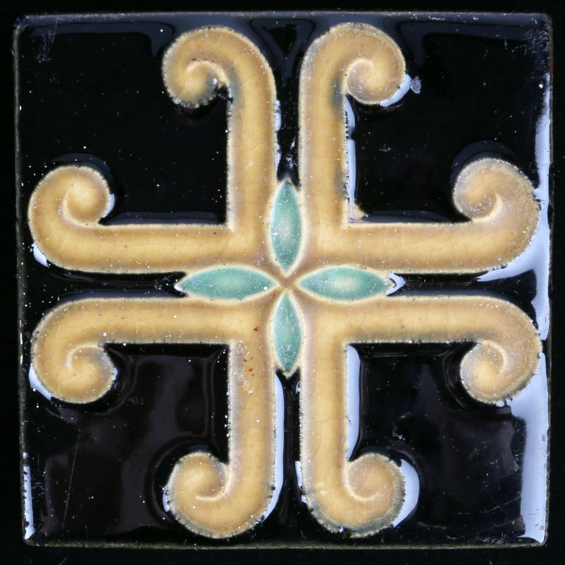 AN ARCHITECTURAL TILE WITH STYLIZED MALTESE CROSS