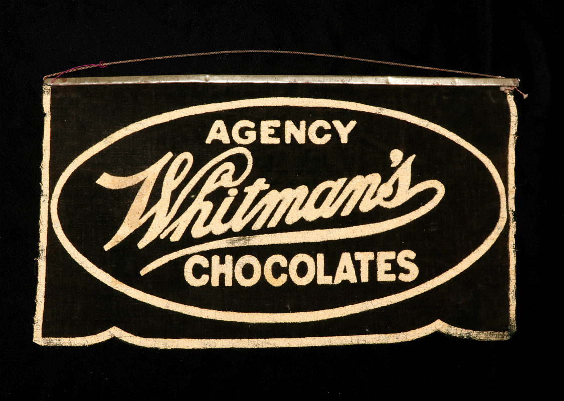 A WHITMAN'S CHOCOLATES ADVERTISING BANNER C. 1920s