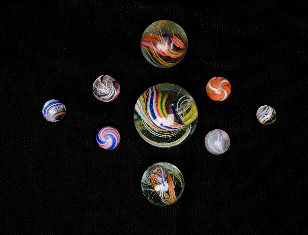 A COLLECTION OF ANTIQUE SWIRL MARBLES