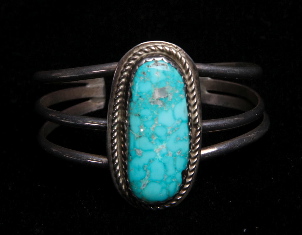 A NAVAJO STERLING AND TURQUOISE CUFF BRACELET