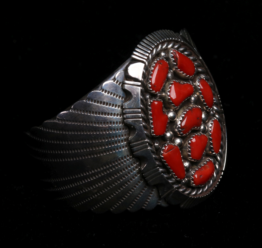 A NAVAJO STERLING AND CORAL CUFF BRACELET