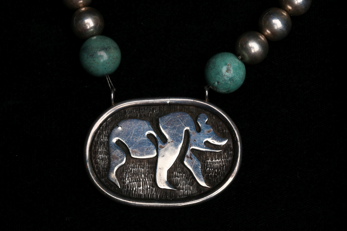 A STERLING SILVER BEAR PENDANT ON BEADED NECKLACE