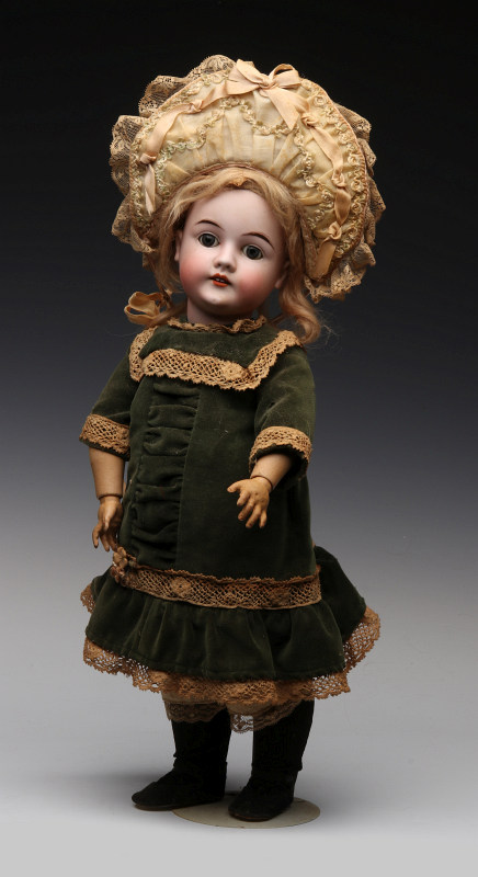 AN ANTIQUE BISQUE HEAD DOLL WITH IMPRESSED MARKS