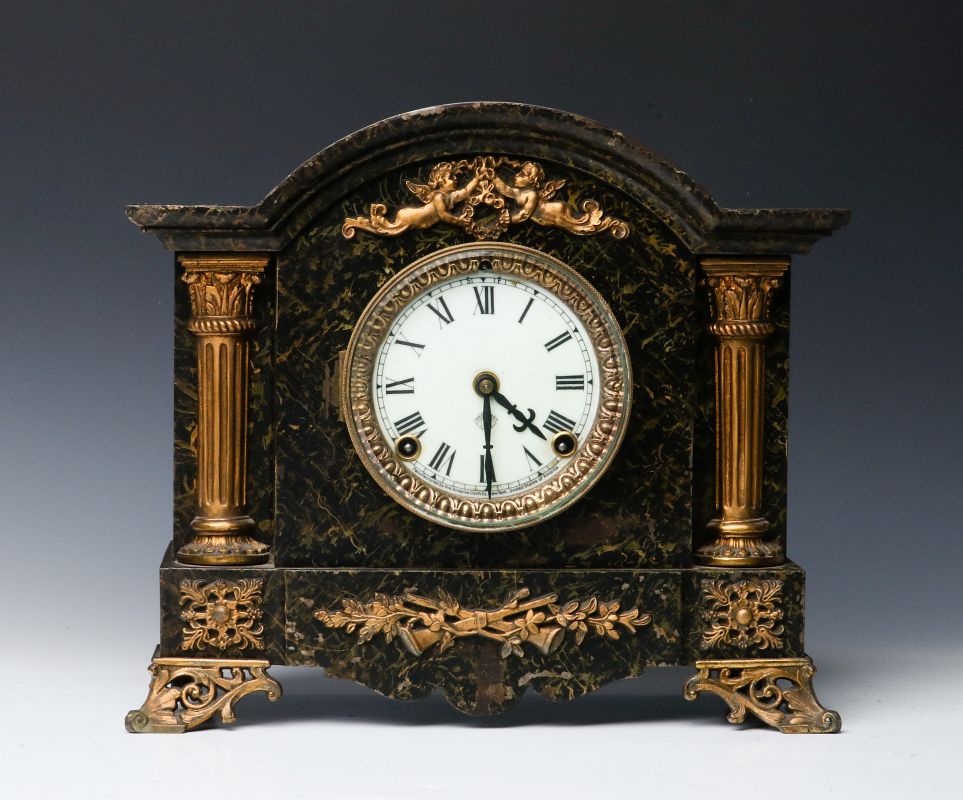 A FAUX MARBLE PAINTED IRON ANSONIA MANTLE CLOCK