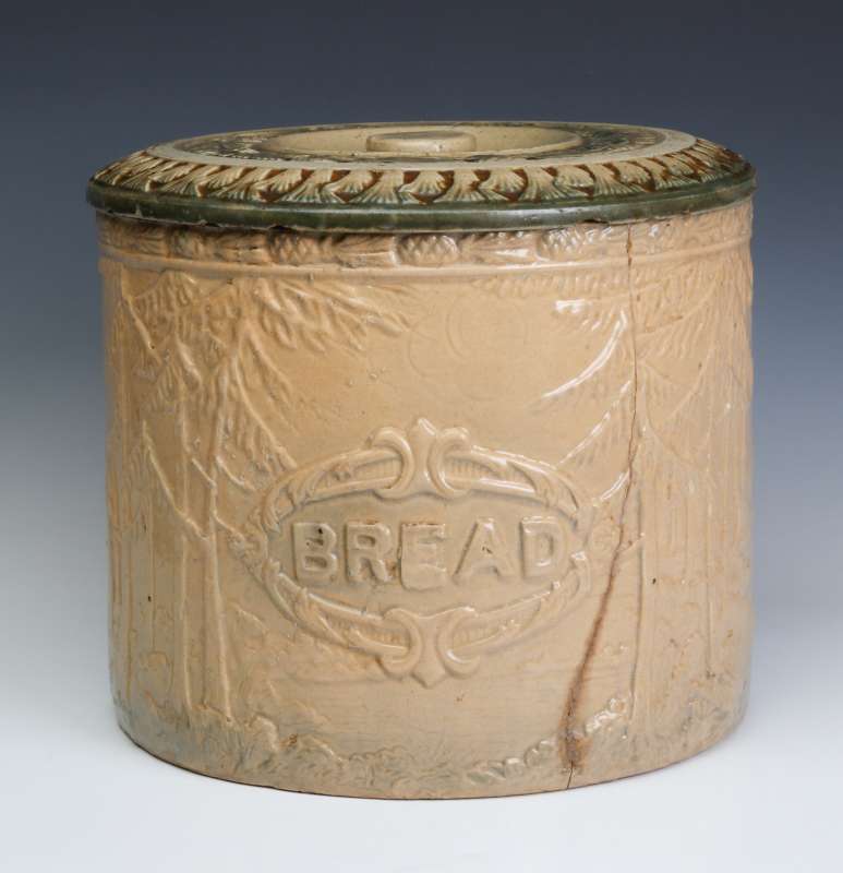A CIRCA 1900 COVERED BREAD CROCK WITH CRACK