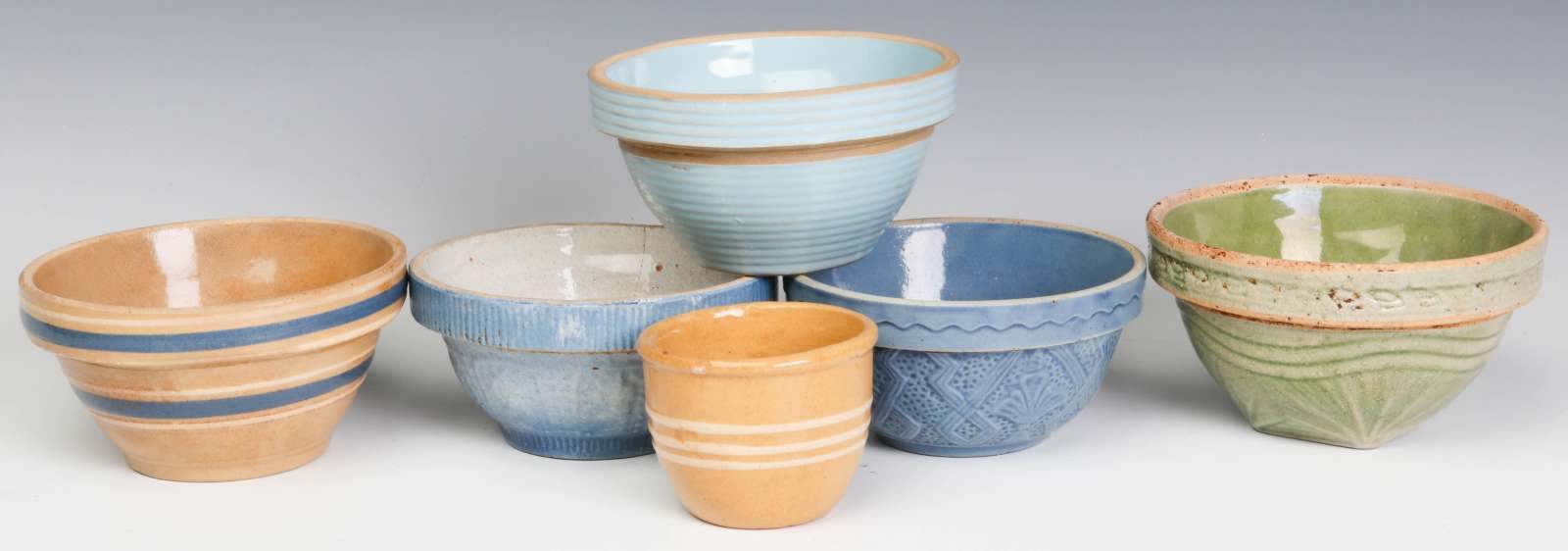 A COLLECTION OF FIVE MINIATURE STONEWARE BOWLS