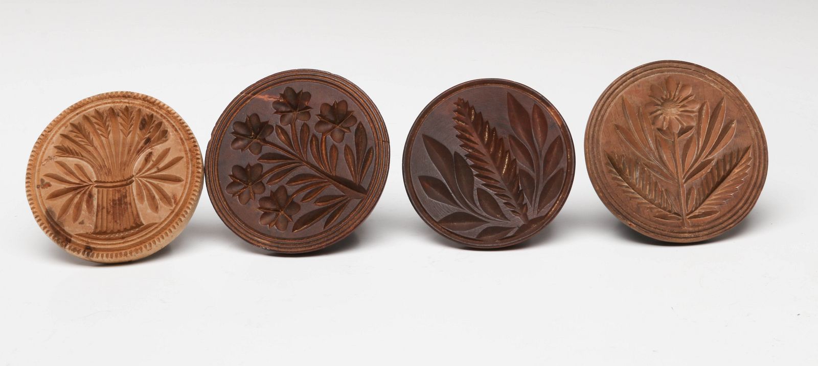 FOUR 19TH C. AMERICAN CARVED WOOD BUTTER STAMPS