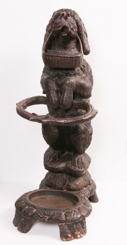 AN EARLY 20TH C BLACK FOREST CARVED DOG CANE STAND