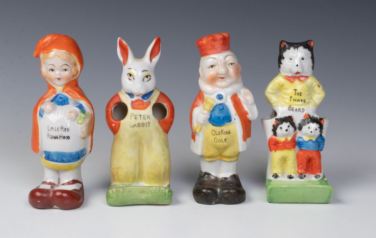 FOUR CIRCA 1930s CHARACTER TOOTHBRUSH HOLDERS