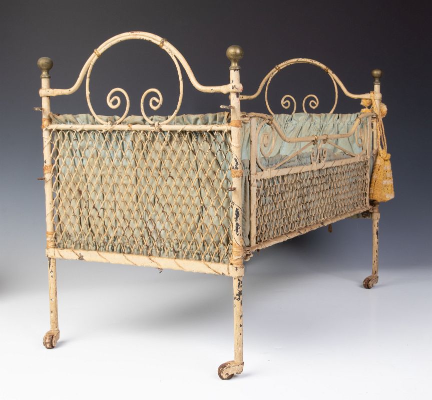 A LATE 19TH CENTURY IRON DOLL BED