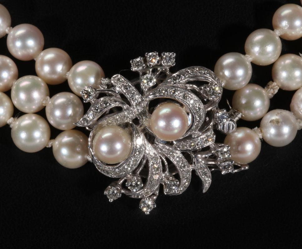 A THREE STRAND PEARL NECKLACE WITH DIAMOND CLASP