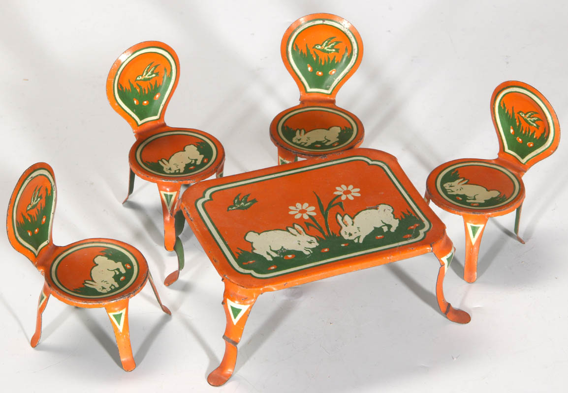 AN ANTIQUE TIN LITHO MINIATURE TABLE AND CHAIRS