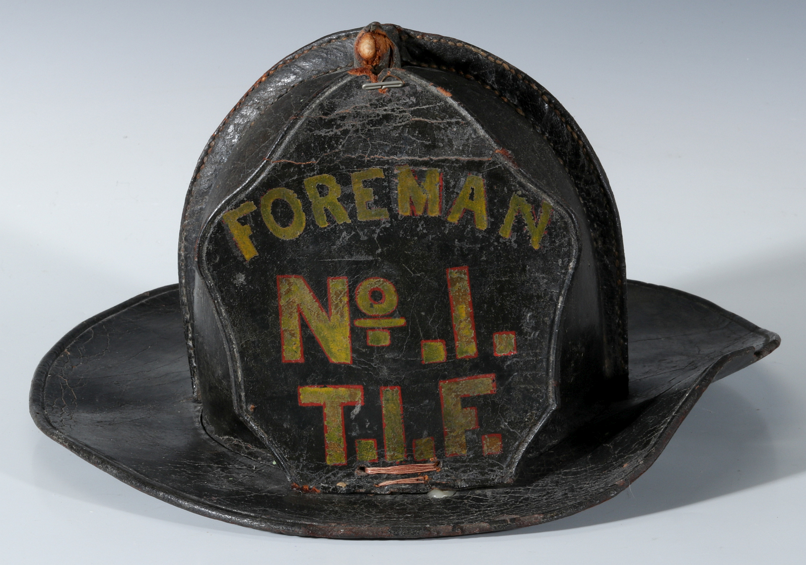 AN EARLY FOREMAN LEATHER FIRE HELMET