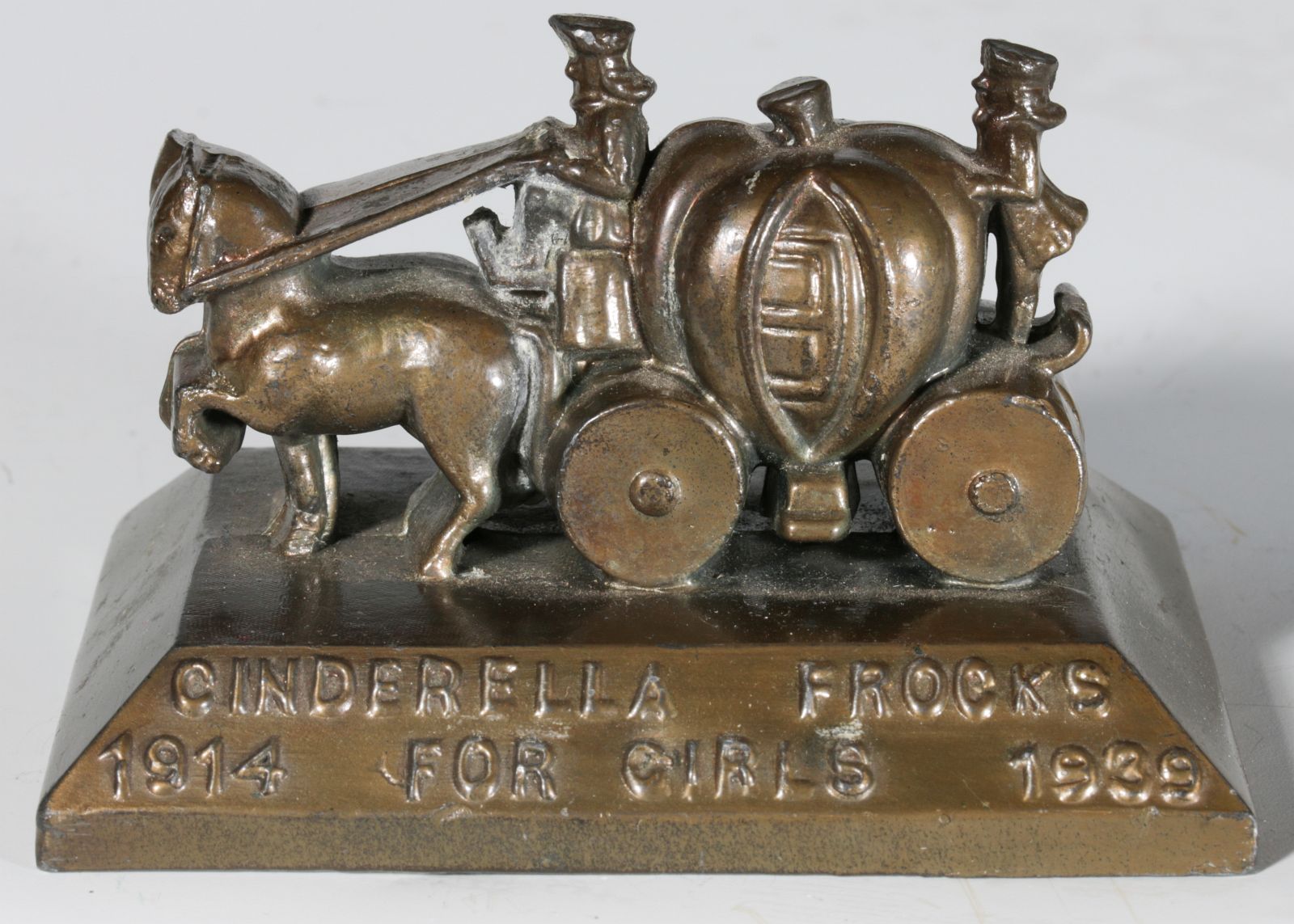 A 1939 'CINDERELLA FROCKS' ADVERTISING PAPERWEIGHT