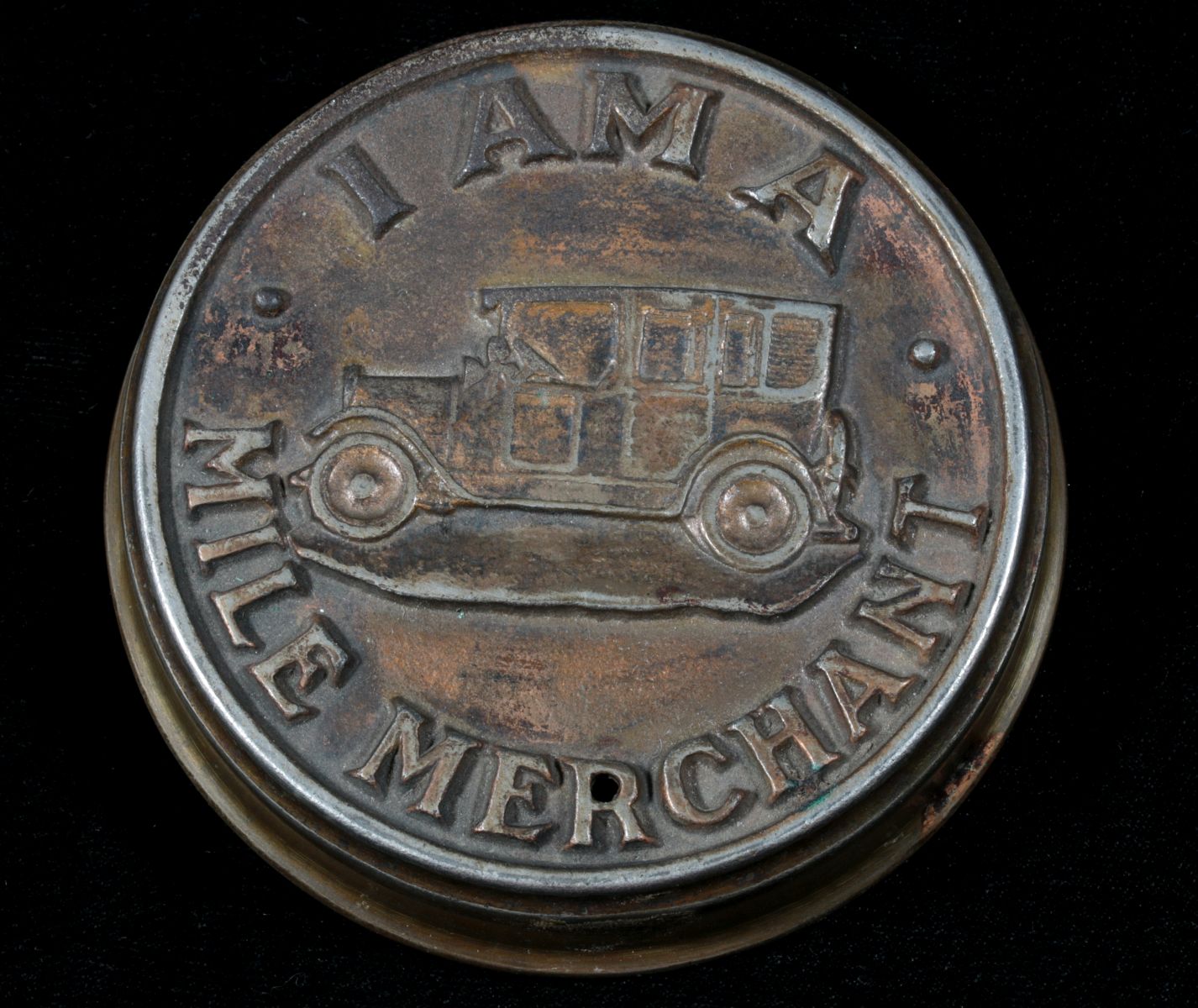 AN ANTIQUE IRON PAPERWEIGHT WITH EARLY AUTOMOBILE